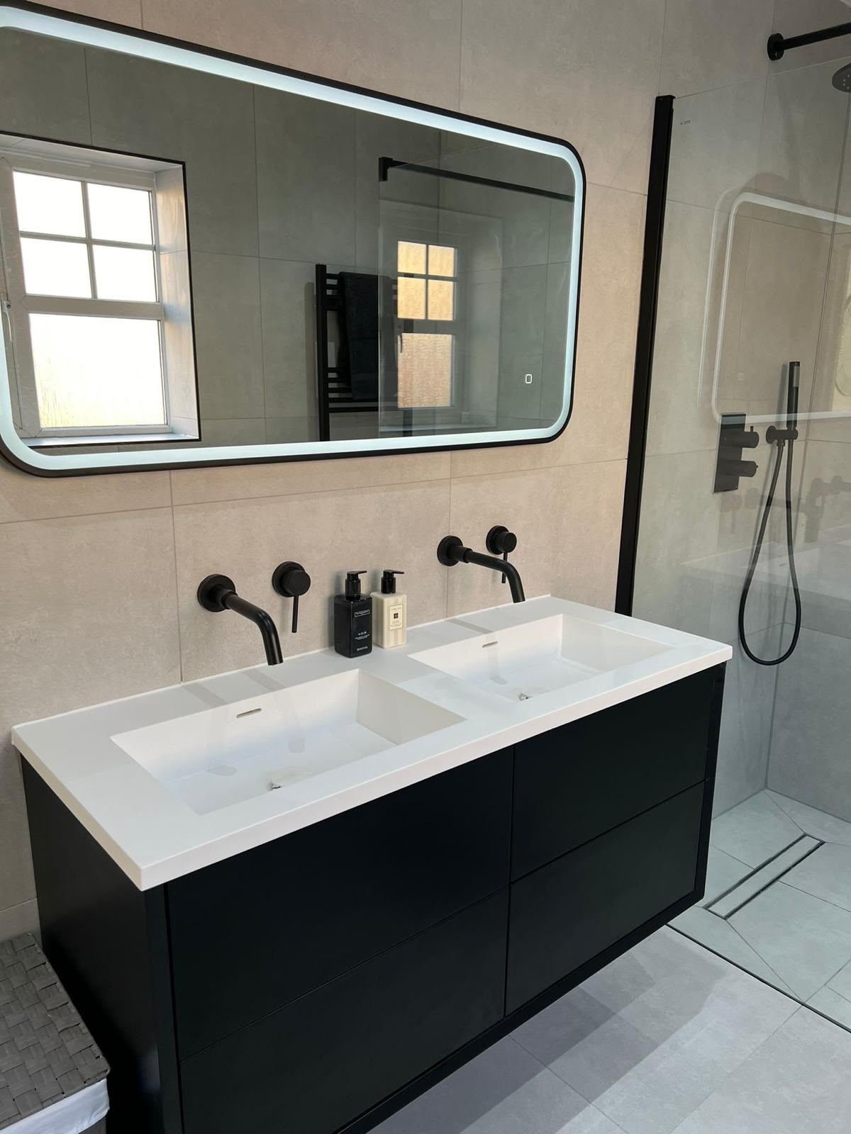 Black double vanity unit with matte black taps