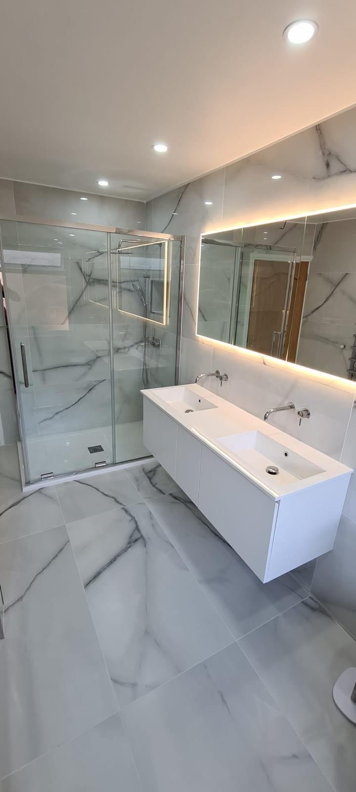 Marble bathroom refurbishment with double vanity and walk-in shower