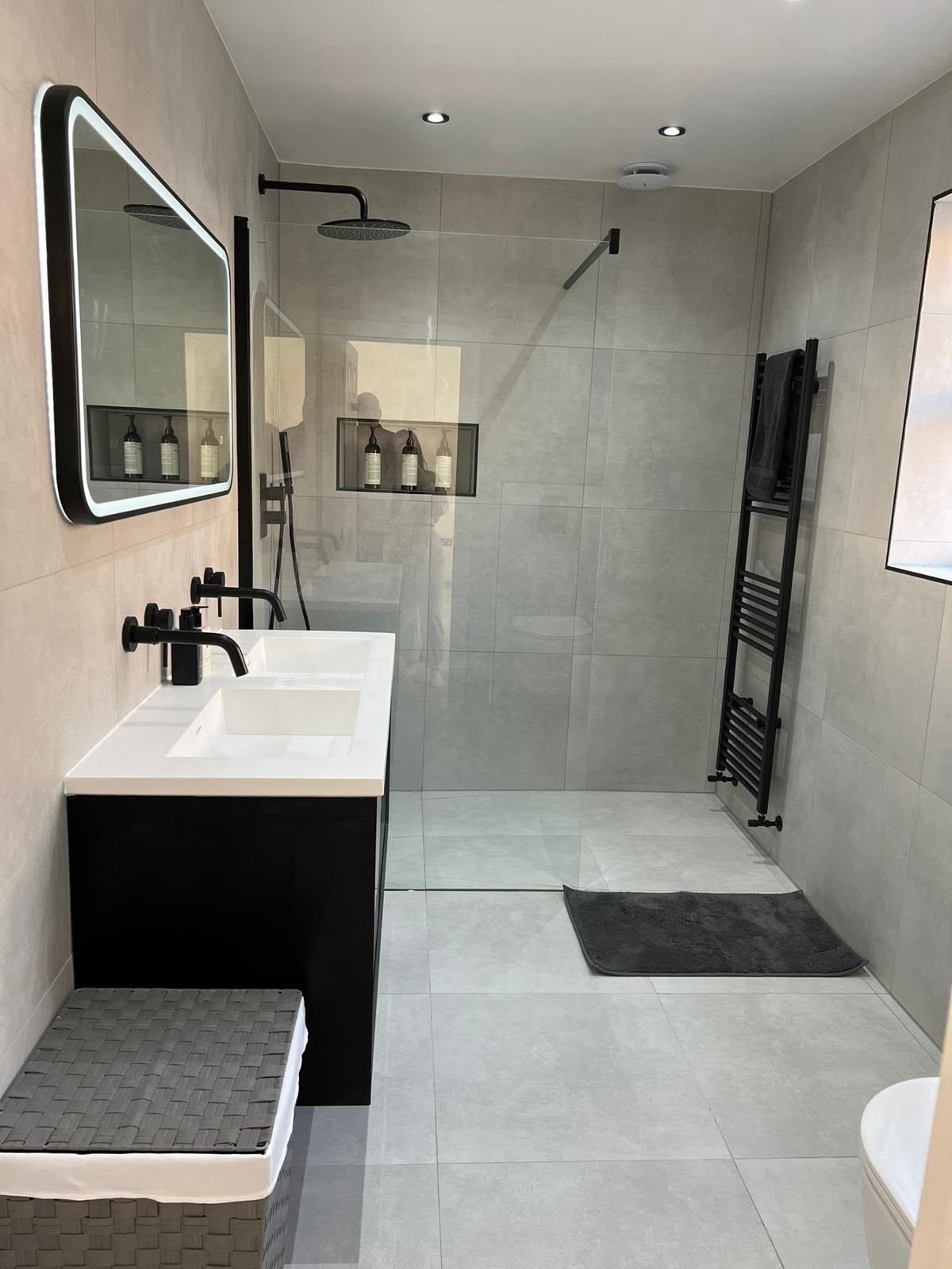 Grey wet room with walk-in shower and black double vanity