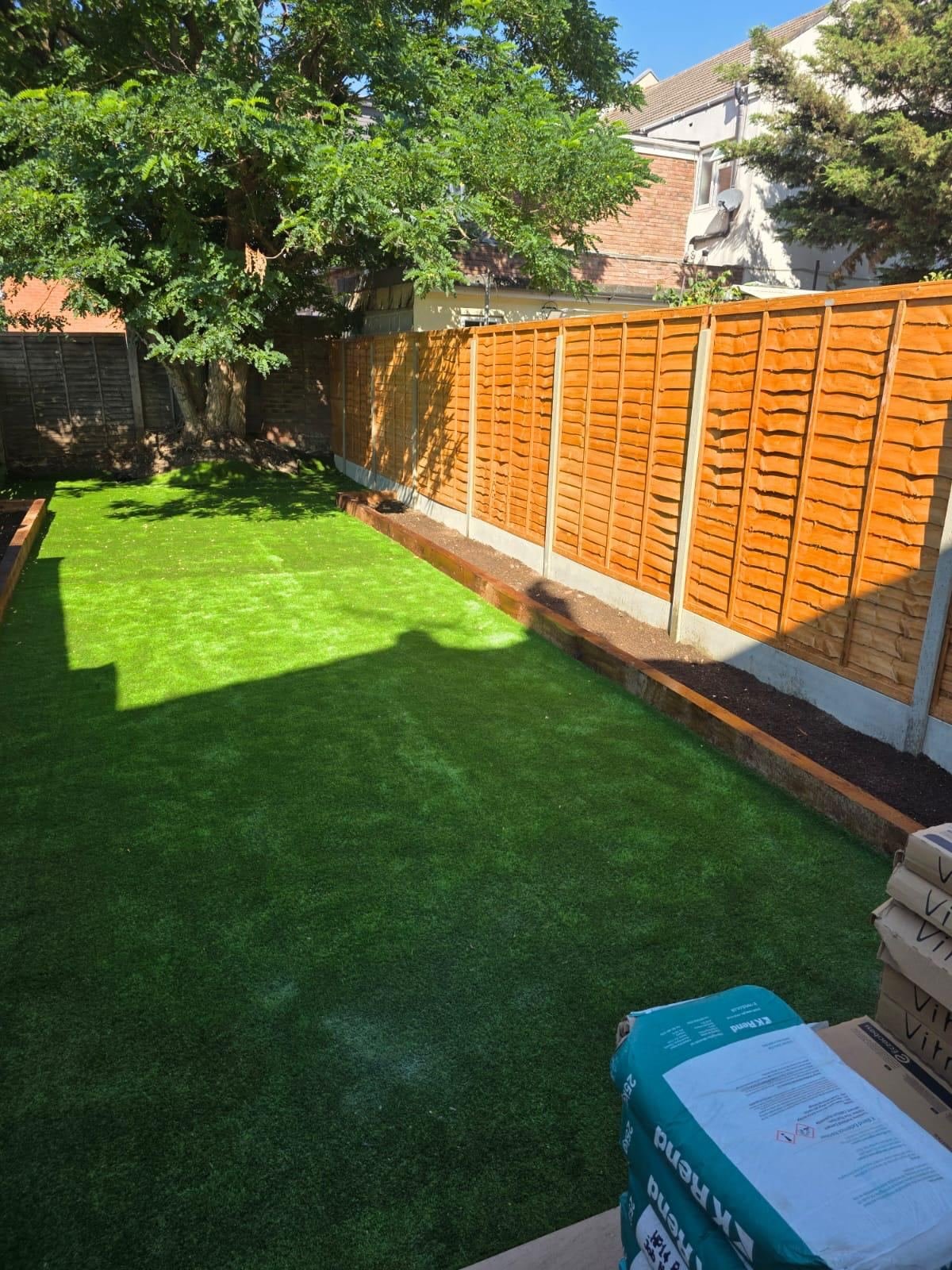 Garden landscaping with sleeper edging and artificial turf