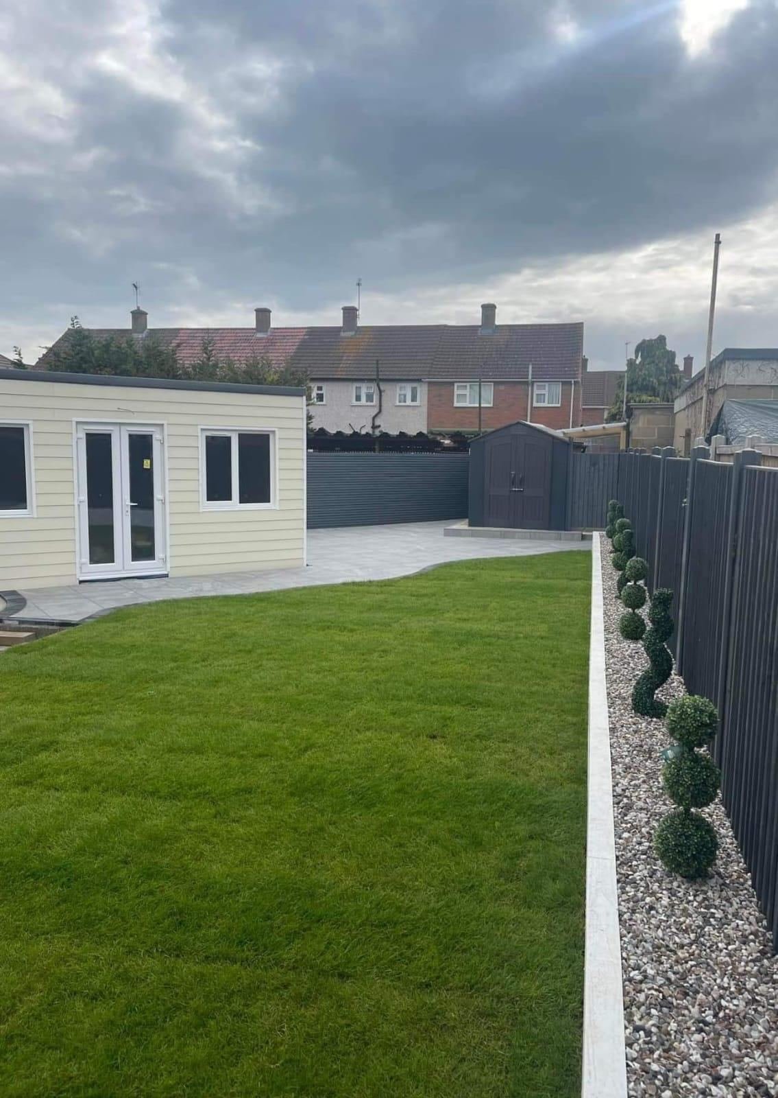 Landscaped garden with lawn, decking and topiary